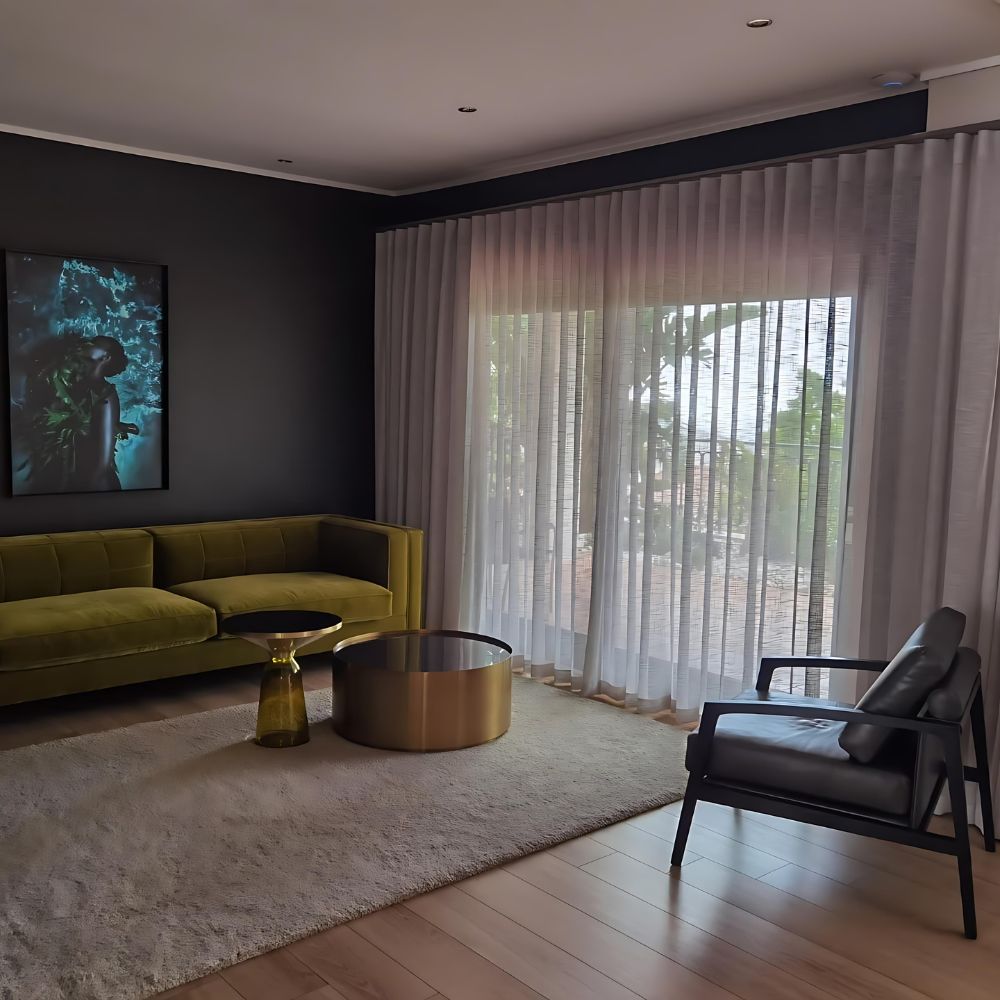 Sheer curtains and a layered window treatment in a living room
